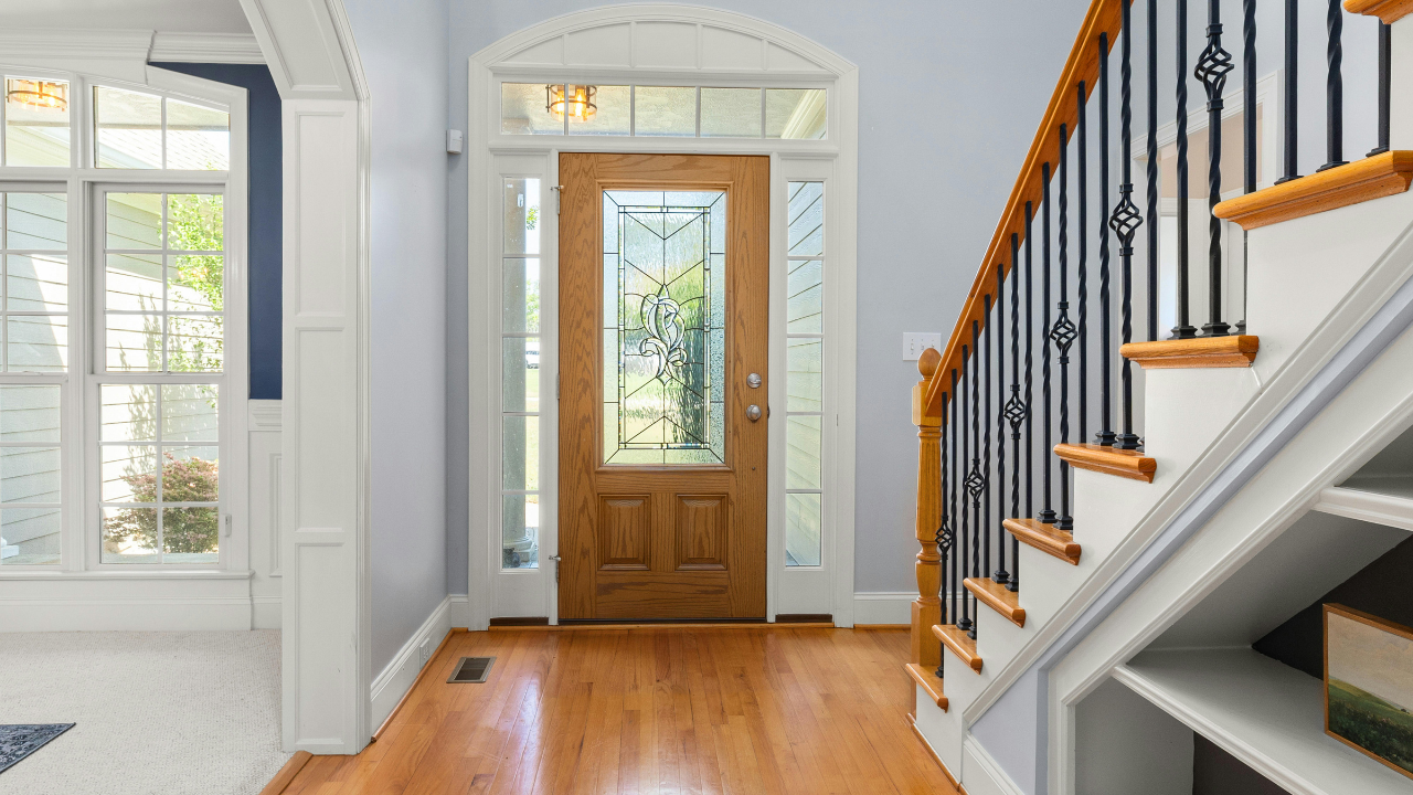Elegant Home Entrance with Wooden Door and Stairs