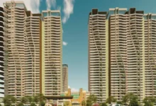 NBCC sells 111 residential flats in Noida through an e-auction, featuring apartment buildings and a residential property development.
